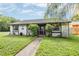 Charming home featuring beautiful landscaping, and a well-maintained green lawn at 16023 Splitlog Dr, Tampa, FL 33618
