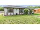 Well-maintained home with a green lawn, decorative plants, and a tidy front yard at 16023 Splitlog Dr, Tampa, FL 33618
