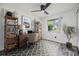 Well-lit home office with desk, shelving, and a view from the bright window at 16023 Splitlog Dr, Tampa, FL 33618