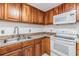 Kitchen featuring stainless steel appliances, tiled floors and wood cabinets at 16023 Splitlog Dr, Tampa, FL 33618