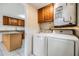 Practical laundry area with washer, dryer, cabinets and granite countertops at 16023 Splitlog Dr, Tampa, FL 33618