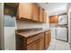 Bright laundry room features wood cabinets with granite countertops and a washer and dryer set at 16023 Splitlog Dr, Tampa, FL 33618
