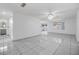Living room with tiled floors, ceiling fan, and view of the backyard at 16023 Splitlog Dr, Tampa, FL 33618