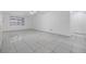 Empty living room with neutral walls, ceiling fan, and tiled floors at 16023 Splitlog Dr, Tampa, FL 33618