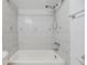 Neat and clean shower-tub combo with white tiles and a chrome shower head at 16023 Splitlog Dr, Tampa, FL 33618