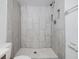 Bright shower stall with tiled walls, a shower head, and a built-in soap holder at 16023 Splitlog Dr, Tampa, FL 33618
