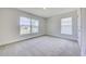Bright bedroom featuring carpet floors and oversized windows, providing plenty of natural light at 16503 66Th E Ln, Parrish, FL 34219