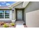 Inviting front entry with a light blue door and landscaped garden at 16503 66Th E Ln, Parrish, FL 34219