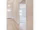 Light and bright hallway with light wood-look tile and an open doorway at 16503 66Th E Ln, Parrish, FL 34219