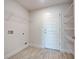 Laundry room featuring tile floors, white wire shelving, and utility connections at 16503 66Th E Ln, Parrish, FL 34219