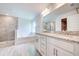 Beautiful main bathroom featuring double sink vanity, soaking tub, and tiled walk-in shower at 16503 66Th E Ln, Parrish, FL 34219