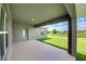 Covered patio overlooking the lush green backyard, perfect for outdoor relaxation and entertaining at 16503 66Th E Ln, Parrish, FL 34219