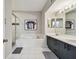 Bathroom with a soaking tub and shower, featuring a dual-sink vanity at 1676 Arabian Ln, Palm Harbor, FL 34685