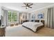 Well-lit bedroom with large window, desk, and sports-themed decor at 1676 Arabian Ln, Palm Harbor, FL 34685