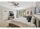 Large bedroom featuring a ceiling fan, big window, TV, and sports memorabilia at 1676 Arabian Ln, Palm Harbor, FL 34685