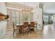 Bright dining room with a wooden table set, stylish chandelier, and plantation shutters at 1676 Arabian Ln, Palm Harbor, FL 34685