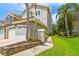 Beautiful multi-story home featuring manicured lawn, an attached garage, and tropical landscaping at 1676 Arabian Ln, Palm Harbor, FL 34685
