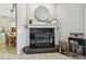 Elegant fireplace with black tile surround, white mantel, and stylish decorative accents at 1676 Arabian Ln, Palm Harbor, FL 34685