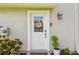 Charming front entrance featuring a decorative door with glass inset, sidelights, and a welcoming monogram at 1676 Arabian Ln, Palm Harbor, FL 34685