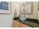 Chic half-bath featuring a vessel sink, modern faucet, and stylish decor at 1676 Arabian Ln, Palm Harbor, FL 34685