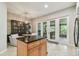 Bright eat-in kitchen features a center island and outdoor access at 1676 Arabian Ln, Palm Harbor, FL 34685
