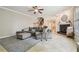 Comfortable living room featuring a large sectional sofa, fireplace, staircase and neutral color palette at 1676 Arabian Ln, Palm Harbor, FL 34685
