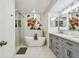 Luxurious main bathroom featuring a soaking tub, and glass shower at 1676 Arabian Ln, Palm Harbor, FL 34685