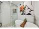 Stylish main bathroom featuring soaking tub, glass shower, and decorative art at 1676 Arabian Ln, Palm Harbor, FL 34685