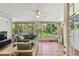 Spacious screened porch with comfortable seating and views of the backyard at 1676 Arabian Ln, Palm Harbor, FL 34685