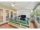 Relaxing screened porch with comfortable seating and a ceiling fan at 1676 Arabian Ln, Palm Harbor, FL 34685