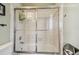 Close up of shower tub combo with sliding glass doors and tiled walls at 1676 Arabian Ln, Palm Harbor, FL 34685
