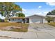 Charming single-story home featuring a two car garage and well-kept front lawn at 1700 Ironwood E Ct, Oldsmar, FL 34677