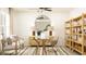 Bright home office featuring a stylish glass desk, modern shelving, and comfortable seating area at 1712 Tropical Oasis Ave, Plant City, FL 33565