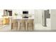 Modern kitchen with an island featuring bar stool seating, stainless steel appliances, and white cabinets at 1712 Tropical Oasis Ave, Plant City, FL 33565