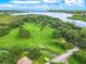 Aerial view of Sheffield Park with a walking path surrounded by lush greenery and a covered picnic area in the distance at 1807 Split Fork Dr, Oldsmar, FL 34677