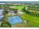 Aerial view of Sheffield Park with tennis and basketball courts, playground, baseball field, and a scenic landscape at 1807 Split Fork Dr, Oldsmar, FL 34677