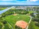 Aerial view of Sheffield Park featuring open baseball fields and the surrounding greenery with a canal in the background at 1807 Split Fork Dr, Oldsmar, FL 34677