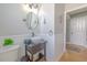 Well-lit bathroom with a vessel sink, decorative mirror and wainscoting at 1807 Split Fork Dr, Oldsmar, FL 34677