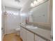 Bright bathroom with a large mirror, a well-lit vanity, and a shower-tub combination for convenience at 1807 Split Fork Dr, Oldsmar, FL 34677