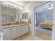 Bright bathroom featuring a soaking tub, shower, and dual vanity with granite countertops at 1807 Split Fork Dr, Oldsmar, FL 34677