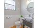 Well-lit bathroom featuring a vessel sink, decorative mirror, and wainscoting at 1807 Split Fork Dr, Oldsmar, FL 34677