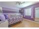 Comfortable bedroom with stylish purple accents, a TV, and a cozy bed, perfect for relaxation at 1807 Split Fork Dr, Oldsmar, FL 34677