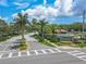 The Eastlake Oaks community entrance has lush landscaping, palm trees, a sign, and a community pool with a covered area at 1807 Split Fork Dr, Oldsmar, FL 34677