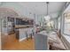 Open-concept floor plan with dining area open to kitchen, hardwood floors and views of the kitchen at 1807 Split Fork Dr, Oldsmar, FL 34677