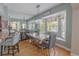 Cozy dining room boasts natural light, a crystal chandelier, hardwood floors, and views of the kitchen at 1807 Split Fork Dr, Oldsmar, FL 34677