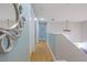 Upstairs hallway with attractive wall color, flooring, lighting, and decor at 1807 Split Fork Dr, Oldsmar, FL 34677