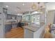 A gourmet kitchen featuring granite countertops, stainless steel appliances, and modern light fixtures at 1807 Split Fork Dr, Oldsmar, FL 34677