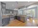 An open kitchen with granite counters, stainless appliances, breakfast nook and dark cabinets at 1807 Split Fork Dr, Oldsmar, FL 34677