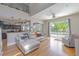 Bright and airy living room featuring hardwood floors and sliding glass doors leading to the backyard pool at 1807 Split Fork Dr, Oldsmar, FL 34677