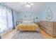Calming bedroom with wooden floors, complemented by a decorative rug and window at 1807 Split Fork Dr, Oldsmar, FL 34677
